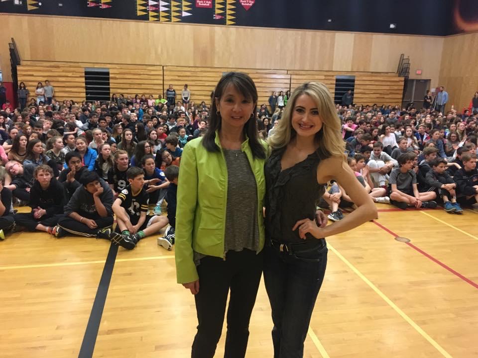 Teresa May speaking to students at Dr. Knox Middle School about mental health in 2018.